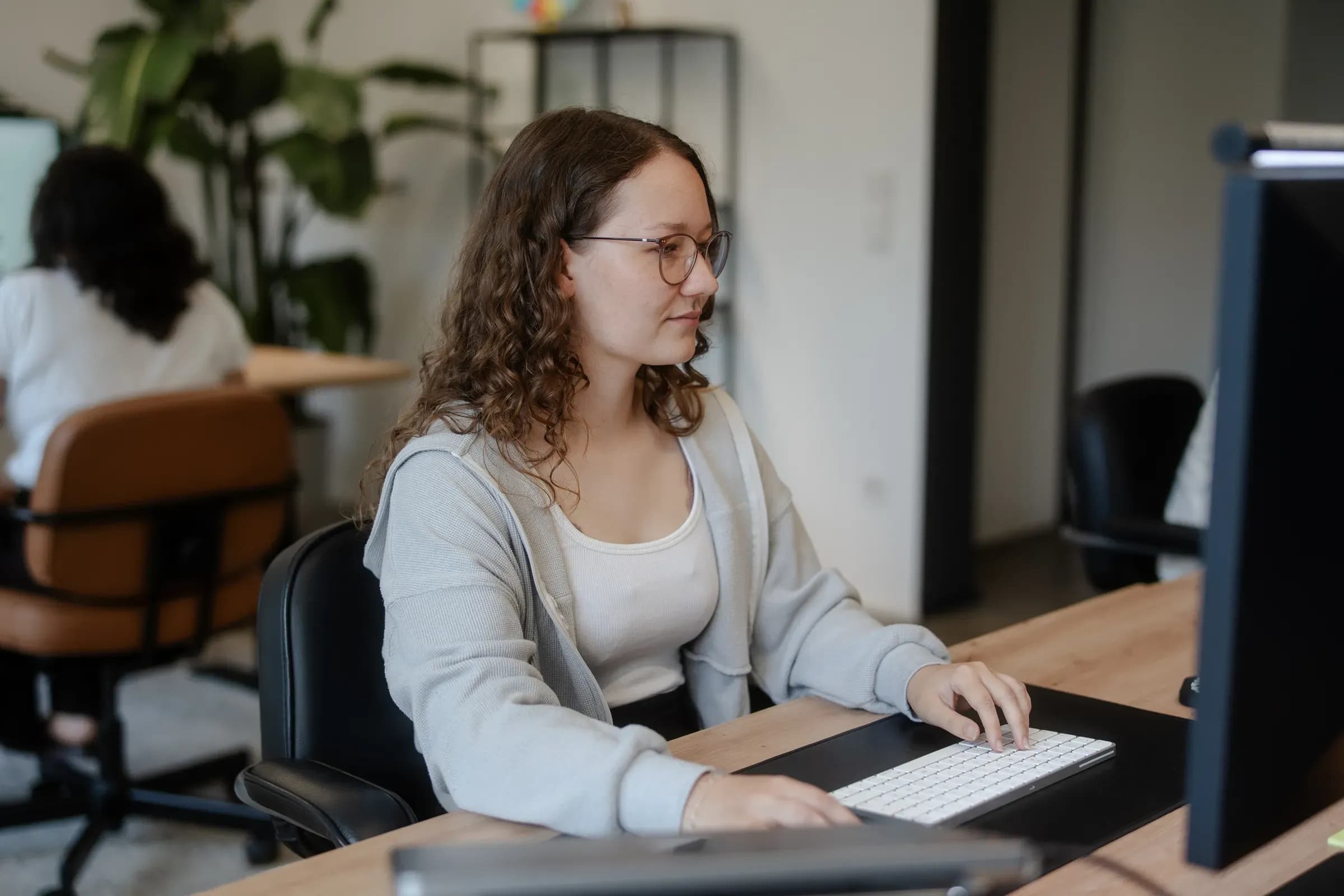 Kollegin von skeon digital am Arbeitsplatz mit Blick auf den Monitor